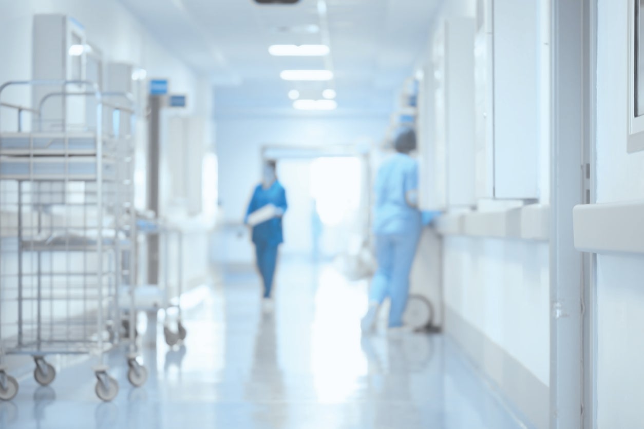 Blurred image of healthcare professionals in hospital hallway
