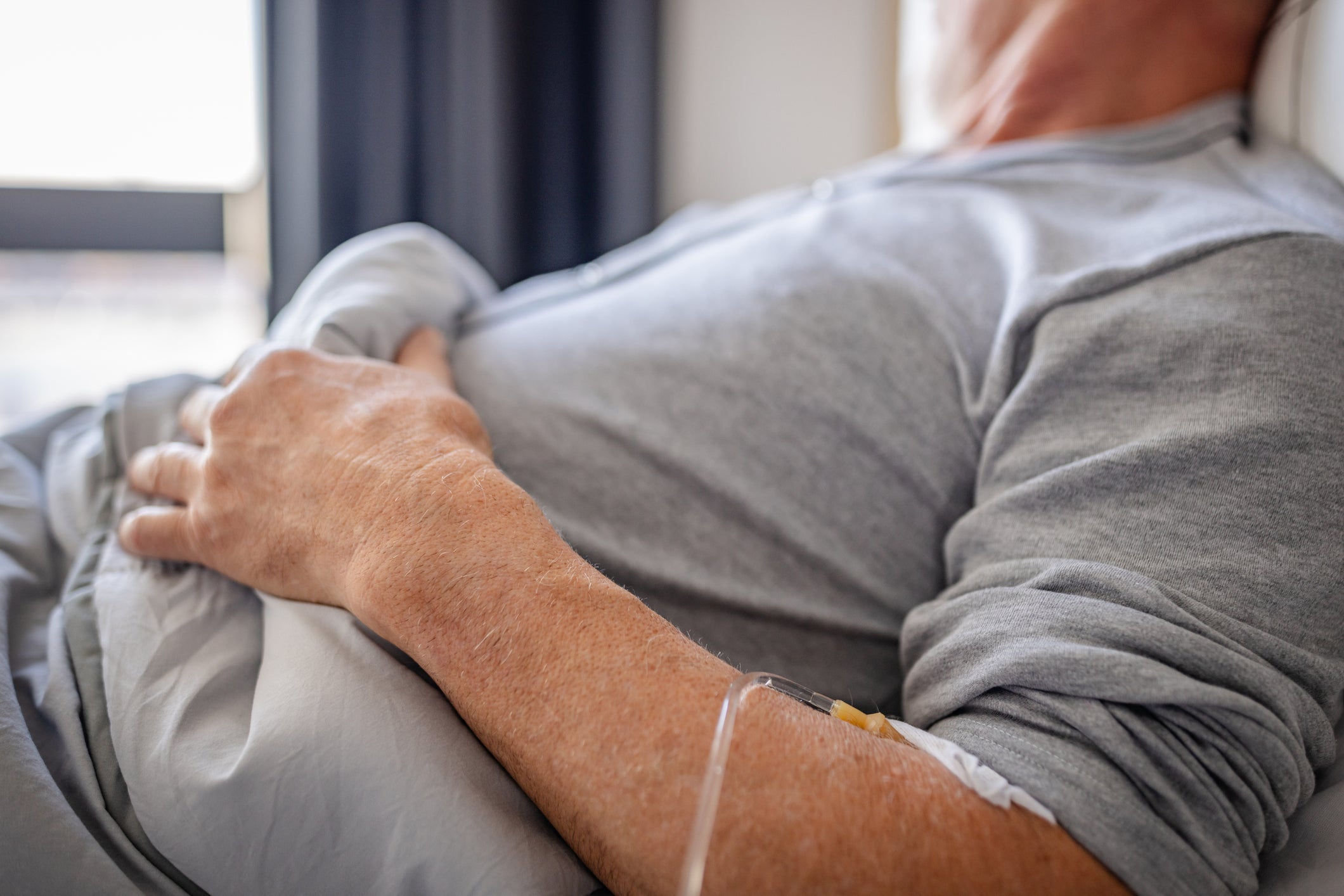 Man receiving dialysis treatment in bed